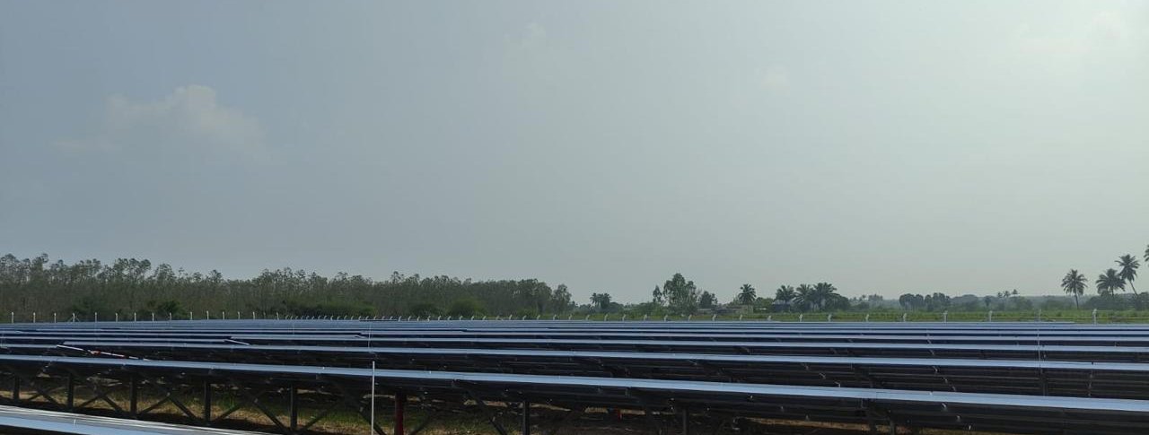 Long rows of ground-mounted solar panels at the Tiruvannamalai site